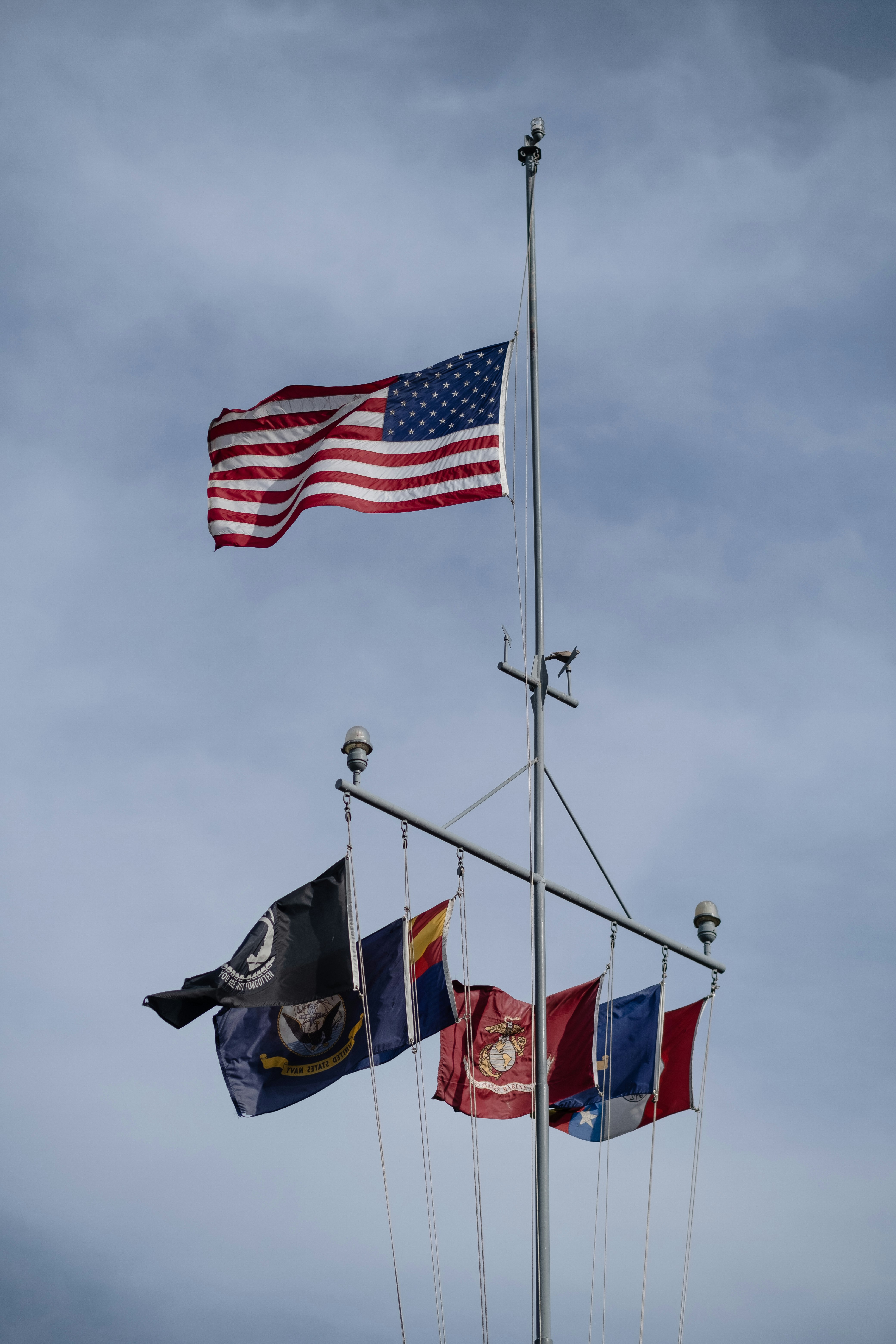 flag of us a on pole under cloudy sky